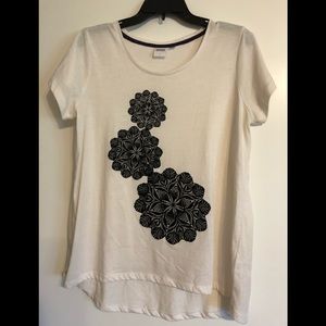 Cream colored top with black lacy flowers